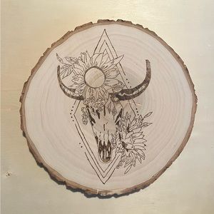 Hand made wood burning of a bull skull and sunflowers.